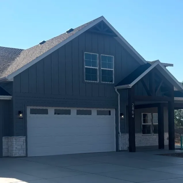 Dark board and batten with stone accents